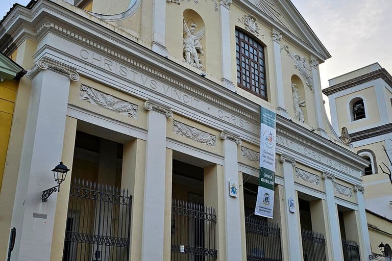 La facciata neoclassica della Cattedrale di Caserta, con il pronao a colonne, l’iscrizione CHRISTVS VINCIT e la statua di San Michele Arcangelo nella nicchia